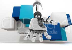 Composite Image of a robotic hand on blue cubes against a white background