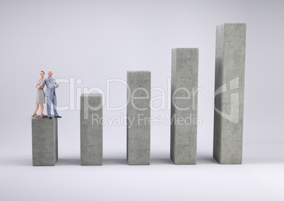 Business man and woman standing on graph against a grey background