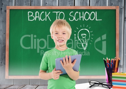 kid and green blackboard with lightbulb against a wood background