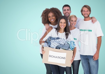 Volunteers Team smiling at camera against a light blue background