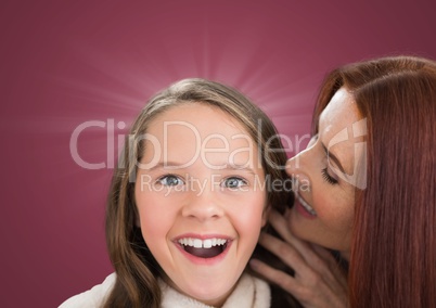 Mother speaking to her dautgher ear against a dark pink background