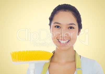 Happy Cleaner lady smiling at camera against a yellow background