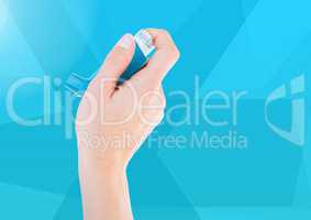 Composite image of Hand holding Ashtma Inhaler against blue background