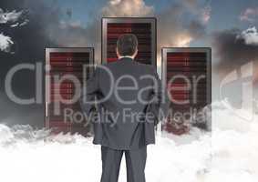 Composite image of Businessman Standing looking at folders against dark sky