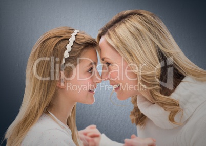 Mother and Daughter Smilling against a grey background