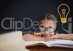 kid and blackboard with lightbulb against a black background