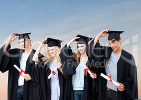 Students Graduation holding their hats against a blue background