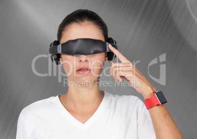 Woman using virtual reality glasses against digitally generated background