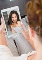 Senior woman having a video call with her daughter in digital tablet