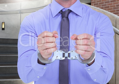 Mid section of corrupt businessman in hand cuffs