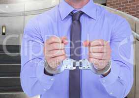 Mid section of corrupt businessman in hand cuffs