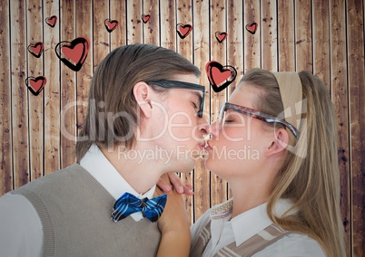 Couple kissing each other against heart drawn on wooden background