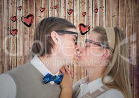 Couple kissing each other against heart drawn on wooden background