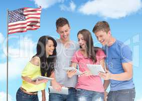Friends using digital tablet against american flag in background