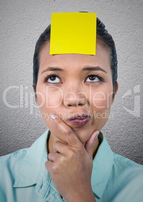 Confused woman with blank sticky note on her forehead