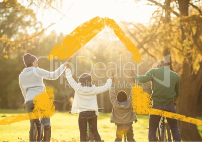 Conceptual image of family on bicycle holding hands on sunny day in park
