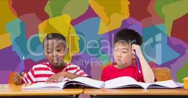 School kids studying at desk in classroom with colorful background