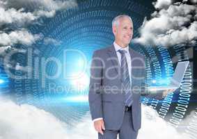 Businessman holding laptop with binary codes and clouds in background