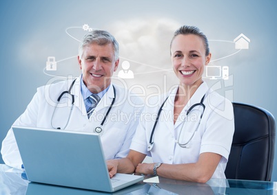 Doctors using laptop at desk against digitally generated background