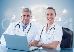 Doctors using laptop at desk against digitally generated background