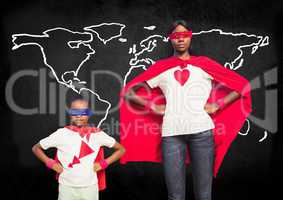 Mother and son in superhero costumes standing against world map in backround