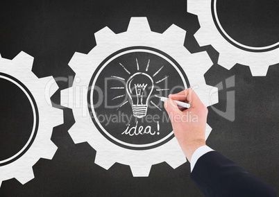 Man drawing electric bulb on blackboard