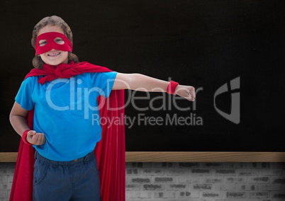Portrait of smiling super kid in red cape and red mask