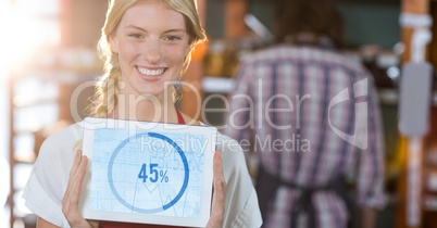 Portrait of smiling executive showing graph chart on digital tablet