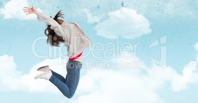 Woman jumping in mid-air against cloudy sky background