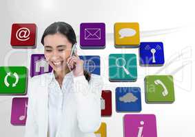 Digital composite image of businesswoman talking on phone with application icons in background