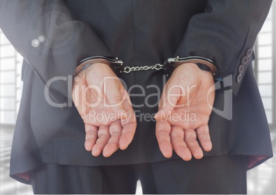 Businessman with hands bonded in hand cuffs