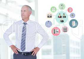 Businessman standing with hands on hips next to application icons