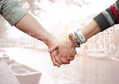 Couple holding hands against city in background