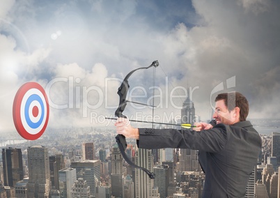 Businessman aiming at the target board against cityscape in background