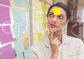 Thoughtful businesswoman with blank sticky note on forehead