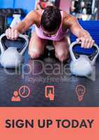 Woman exercising with kettle bells in gym