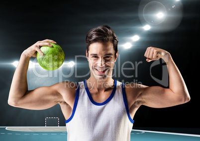 Portrait of man holding a handball and flexing muscles