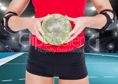 Mid section of woman holding handball at handball court