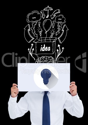 Conceptual image of businessman covering face with paper against black background