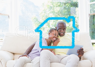 Home outline with couple using digital tablet at home