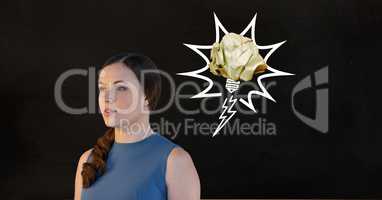 Thoughtful female executive standing against black background