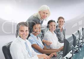 Portrait of smiling customer service peoples with headphones working on computer