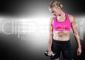 Healthy woman working out with dumb bells