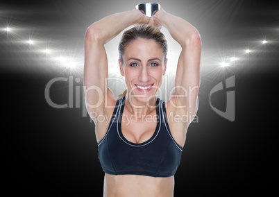 Fitness woman performing tricep exercise against black background
