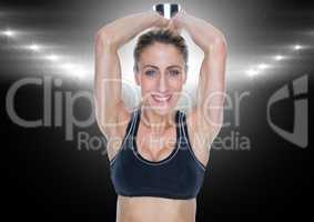 Fitness woman performing tricep exercise against black background