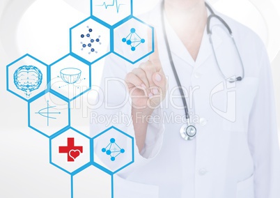 Mid section of doctor touching digitally generated medical icons