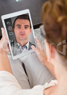 Senior woman having a video call with her son in digital tablet