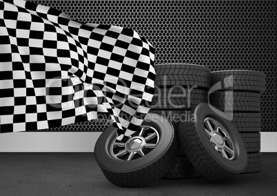 Stack of tires with checkered flag against black background