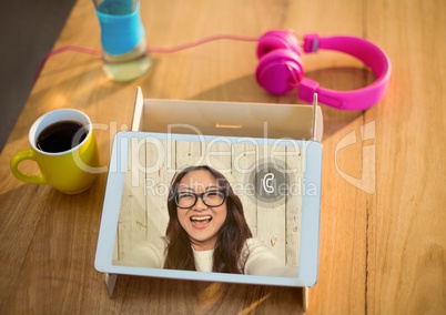 Digital tablet kept on table with video calling screen