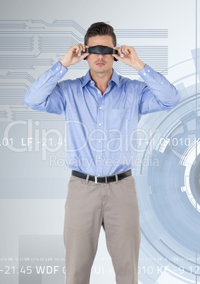 Man using virtual reality headset against cog wheel background
